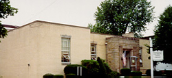 The library on Elm Street showing a beige brick building with a stone entrance